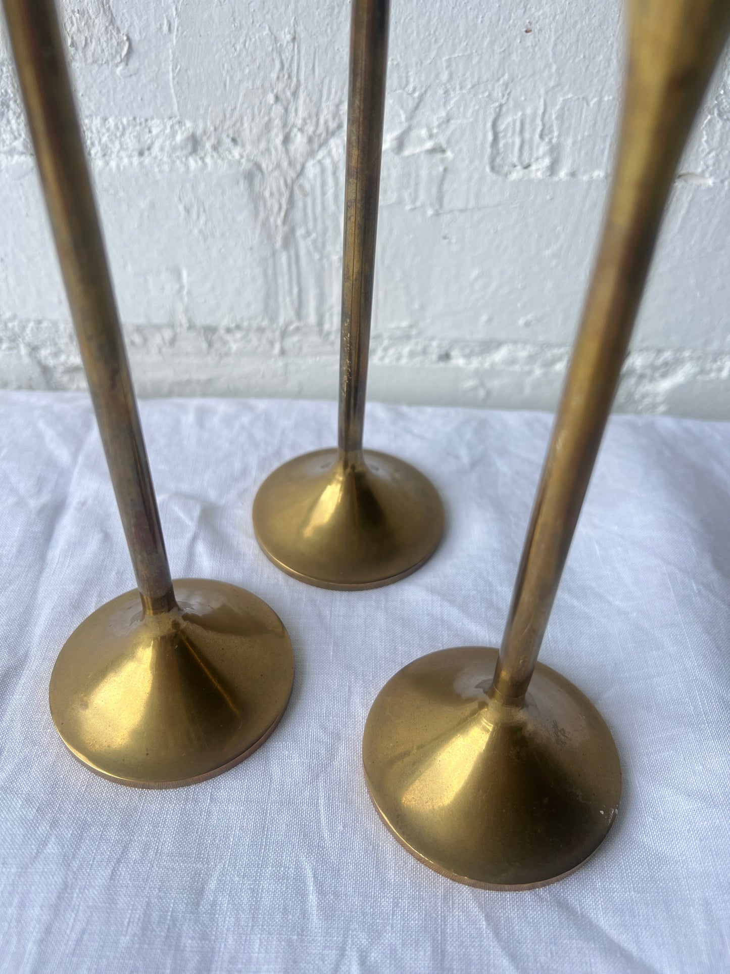 TRIO OF BRASS CANDLE HOLDERS
