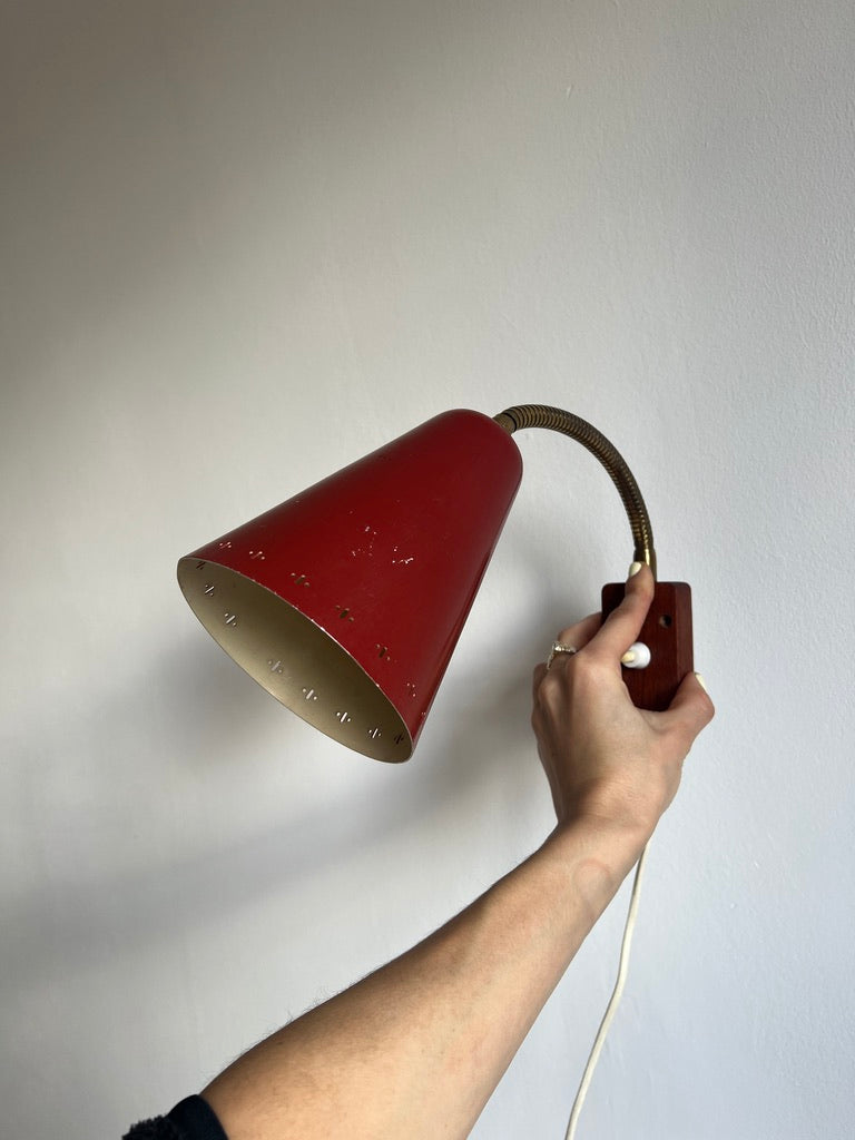 A pair of red and brass bendable matching bedside lights