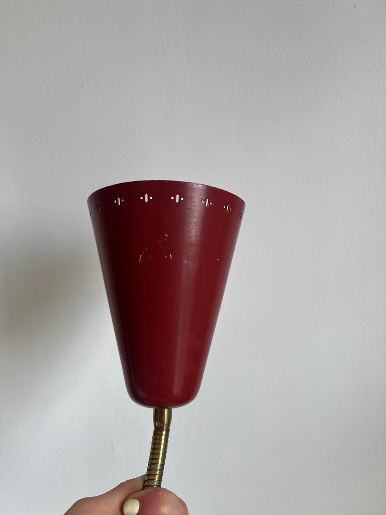 A pair of red and brass bendable matching bedside lights