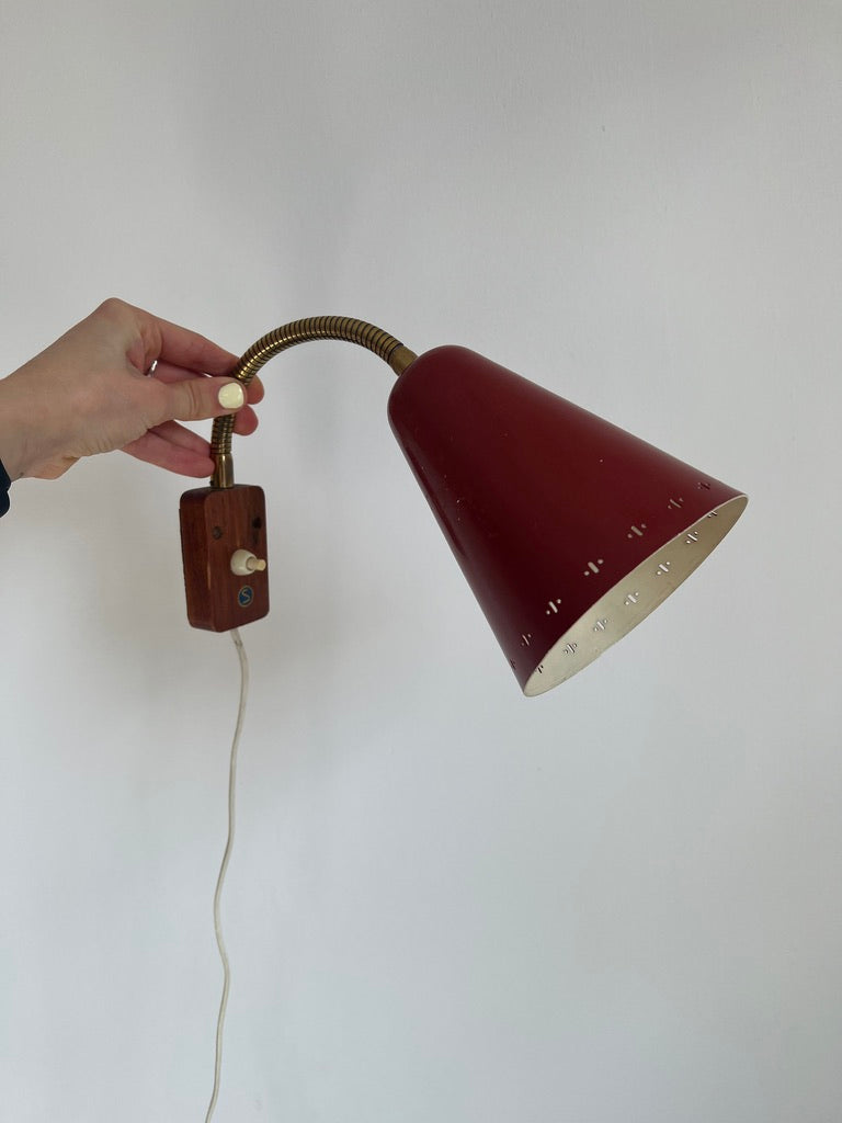 A pair of red and brass bendable matching bedside lights