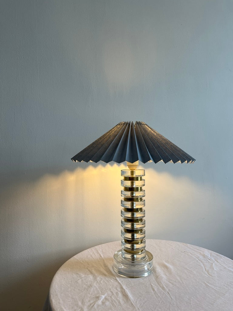 Tall mid century glass lamp with gold detailing and blue pleated shade