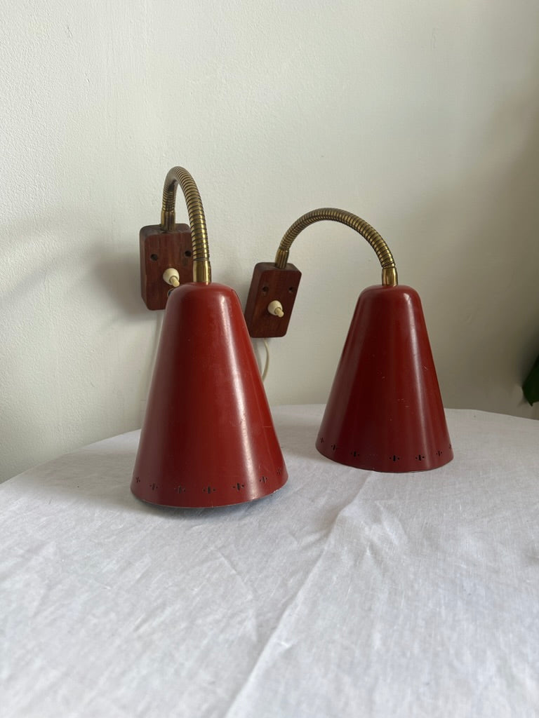 A pair of red and brass bendable matching bedside lights
