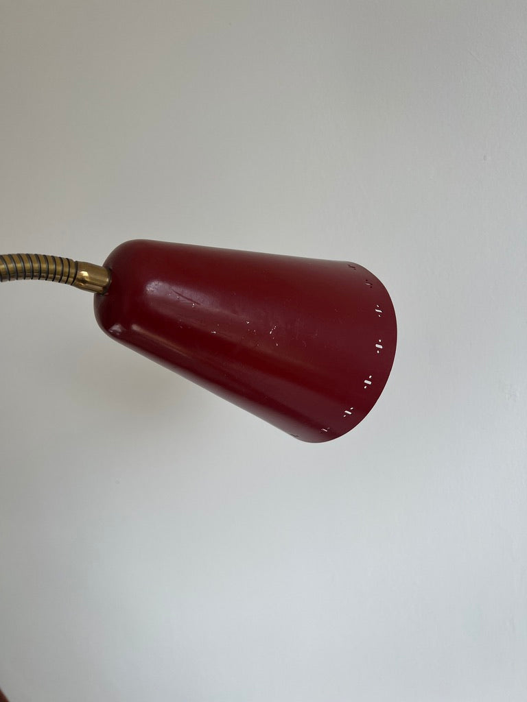 A pair of red and brass bendable matching bedside lights