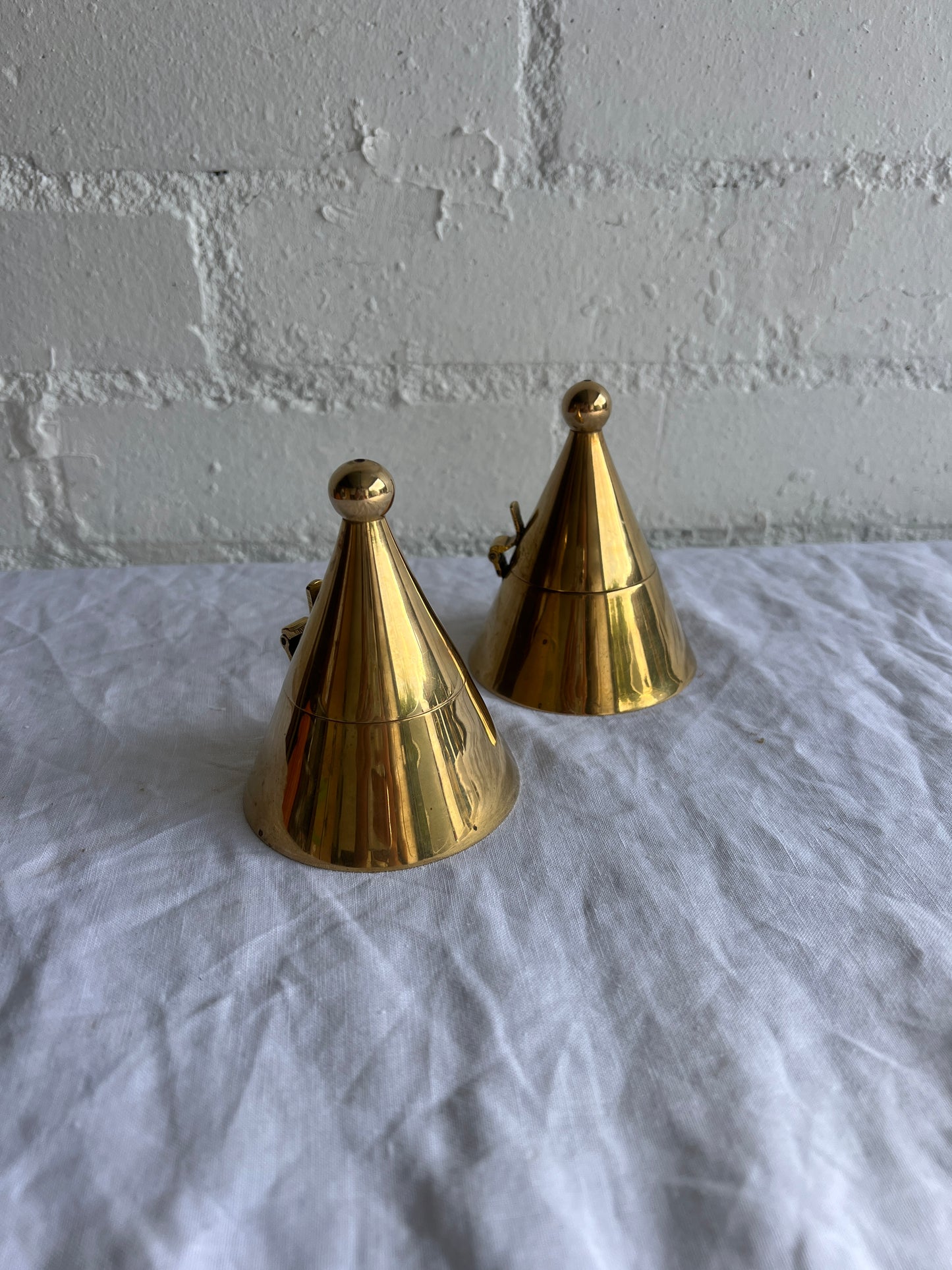 PAIR OF BRASS CONE TEA LIGHT HOLDERS