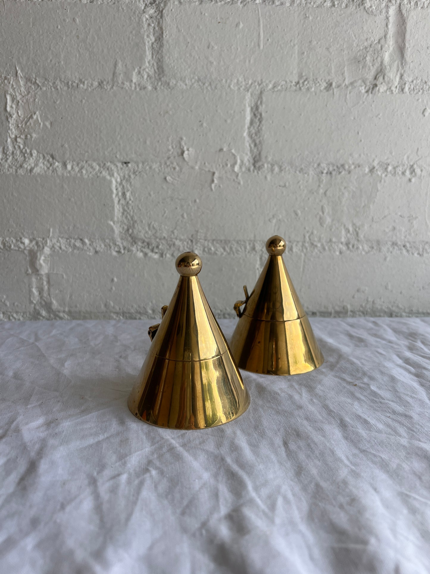 PAIR OF BRASS CONE TEA LIGHT HOLDERS