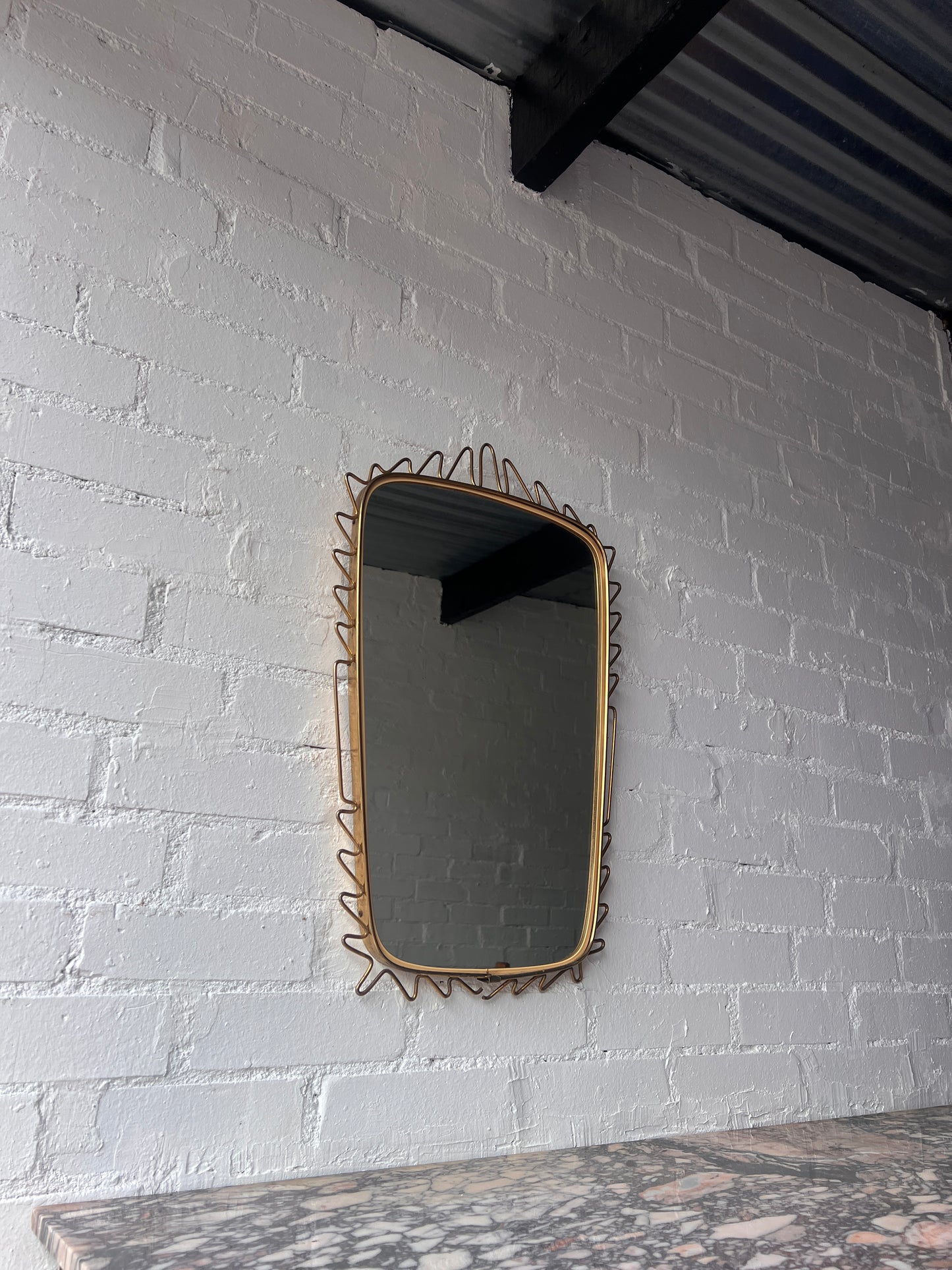 MID CENTURY BRASS WIGGLE MIRROR