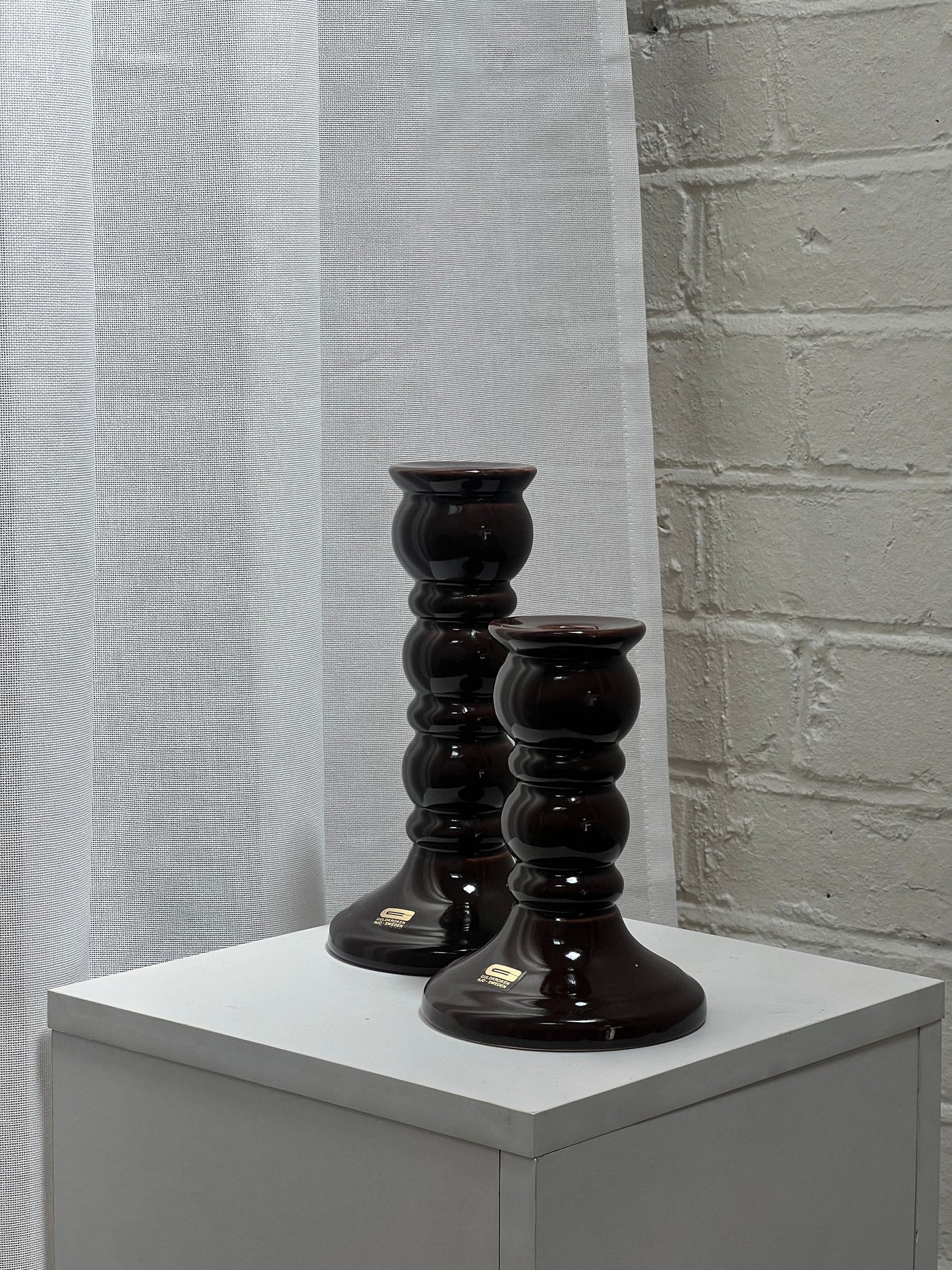 PAIR OF GLOSSY BROWN CANDLE STICKS
