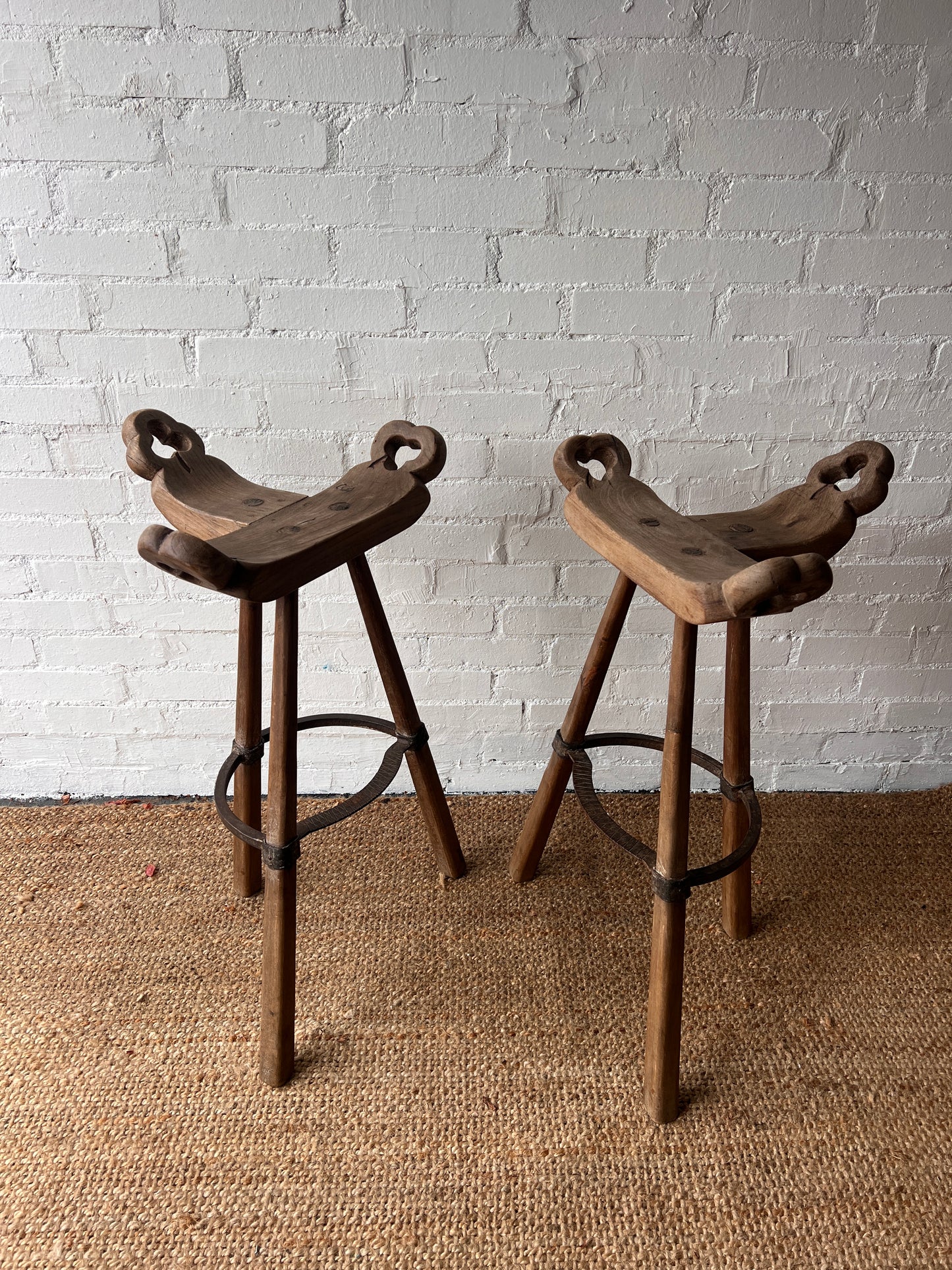 PAIR OF BRUTALIST SADDLE WOODEN STOOLS