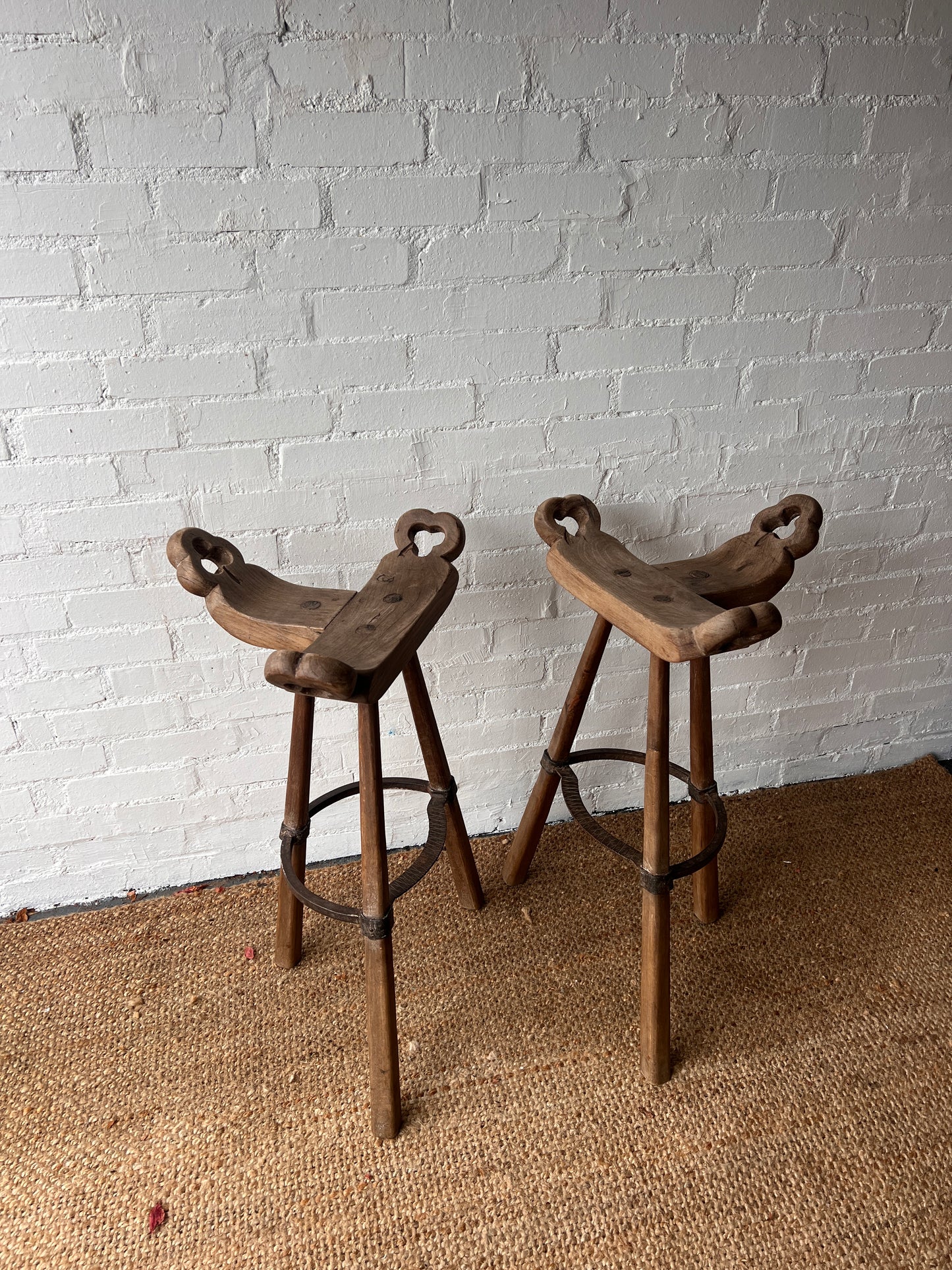 PAIR OF BRUTALIST SADDLE WOODEN STOOLS