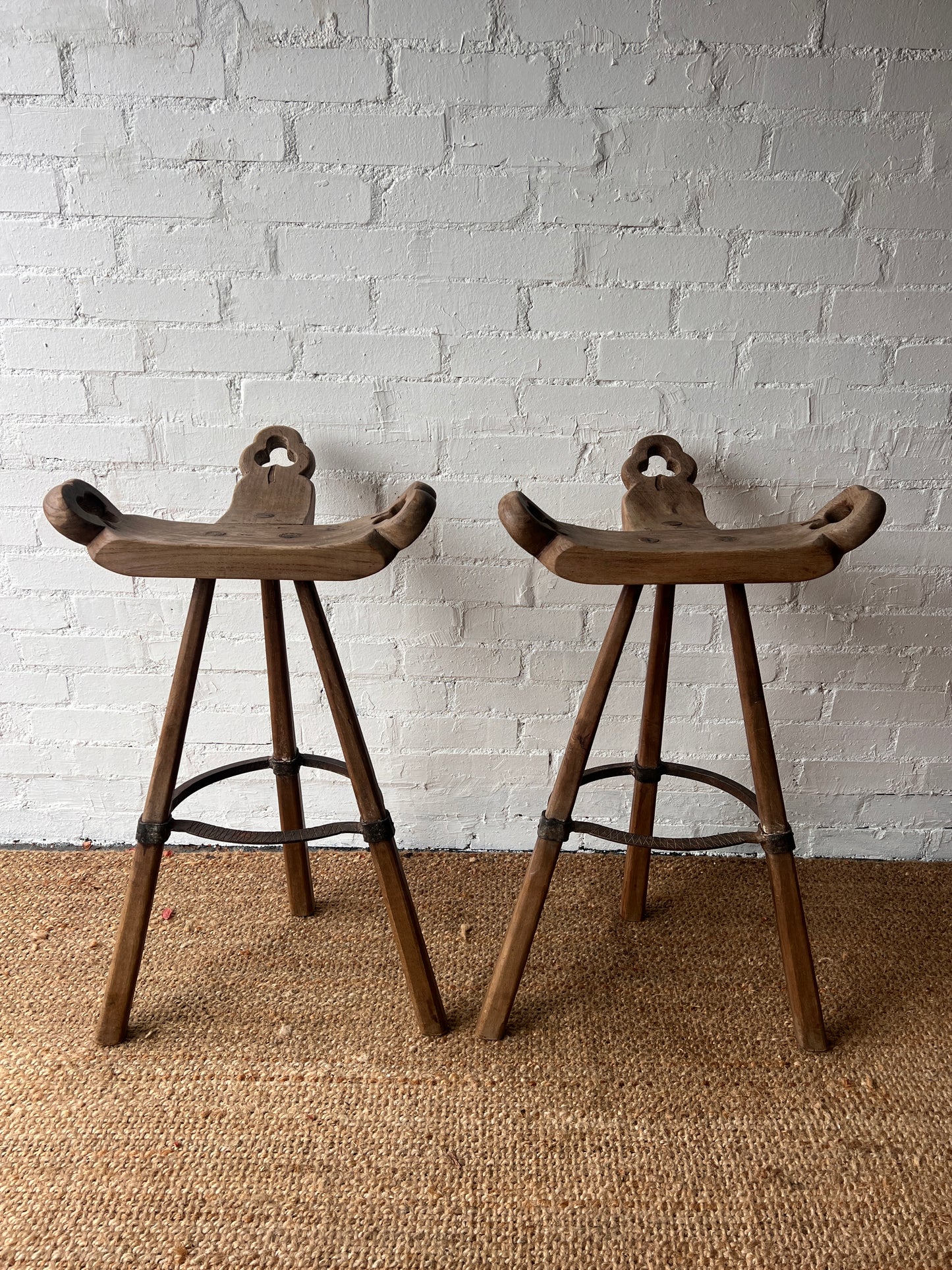 PAIR OF BRUTALIST SADDLE WOODEN STOOLS