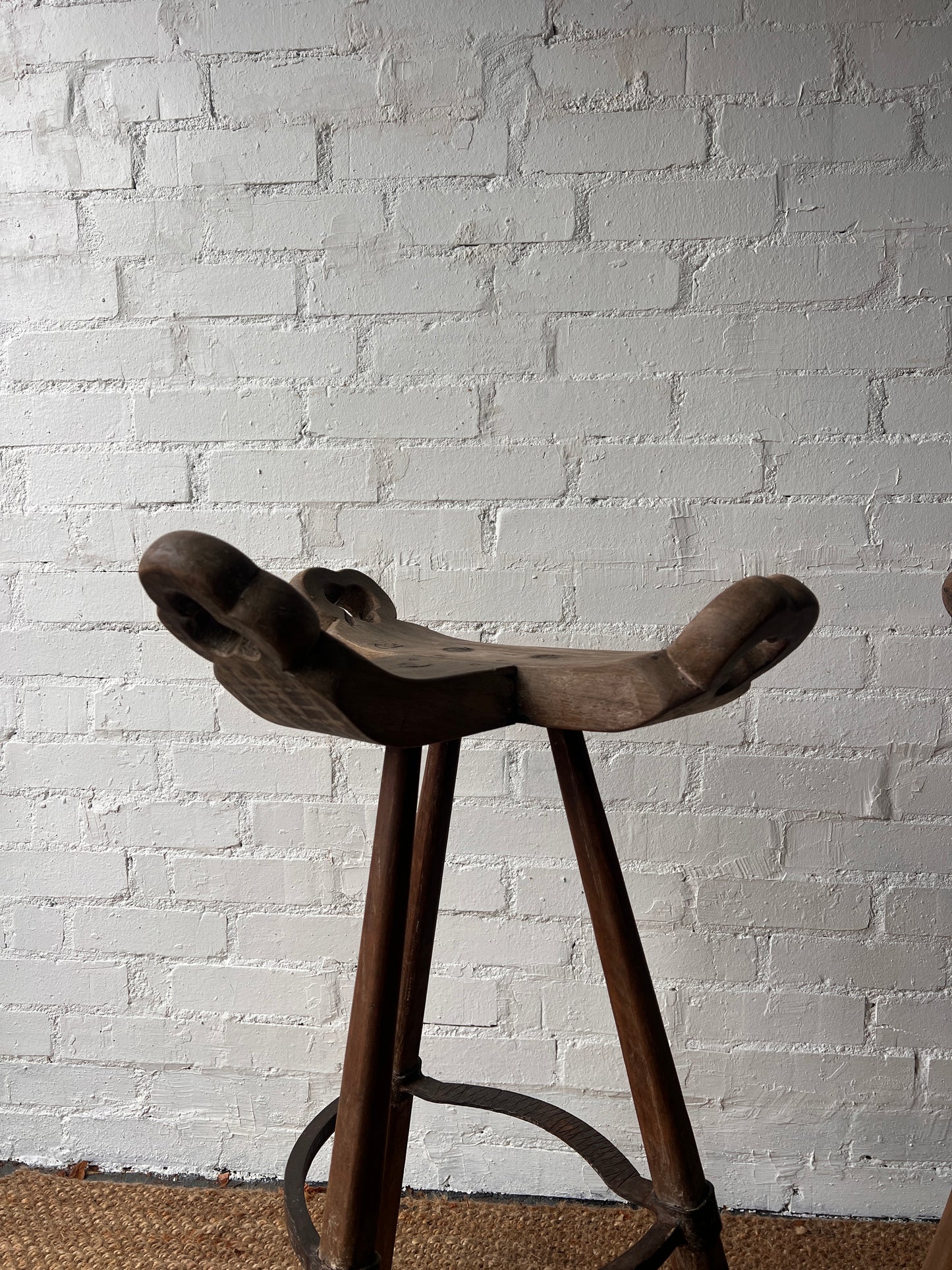 PAIR OF BRUTALIST SADDLE WOODEN STOOLS