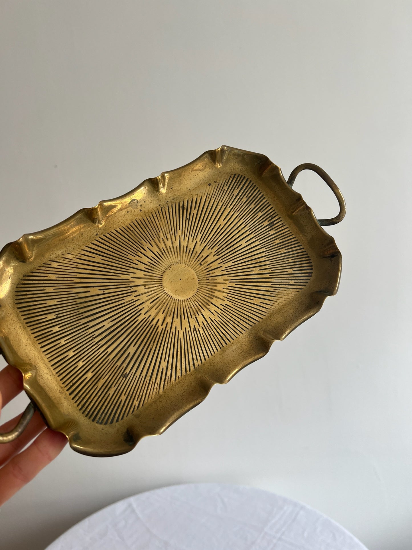 Vintage brass small sunburst tray with a wavy edge and ball feet