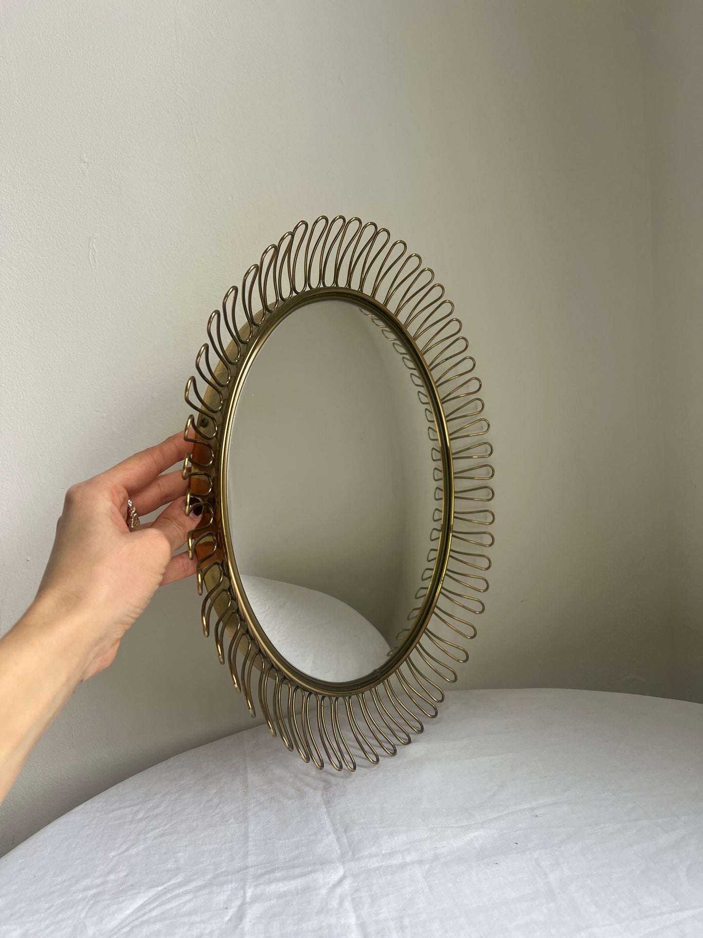 Circular brass convex mirror in the style of Josef Frank