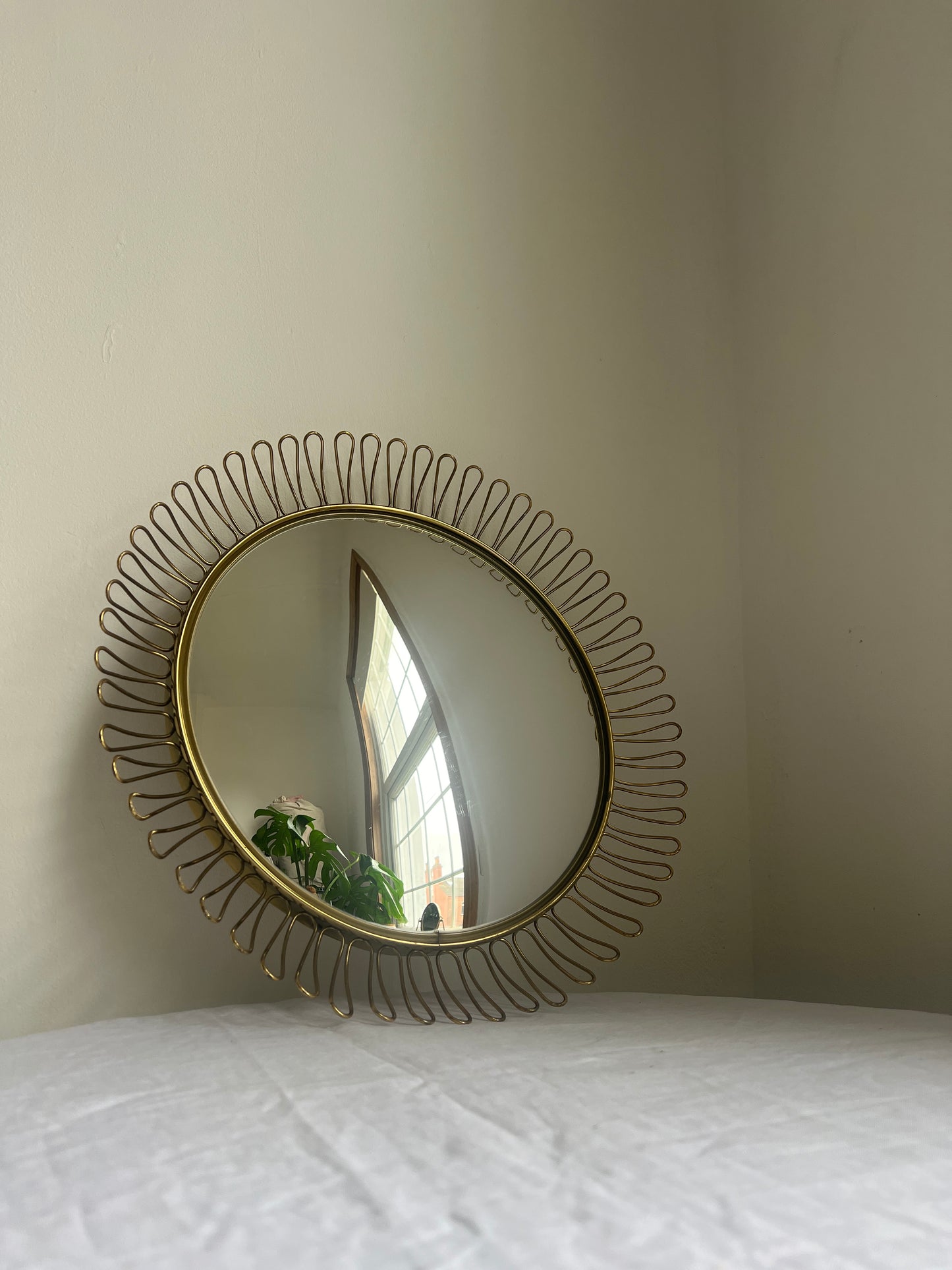 Circular brass convex mirror in the style of Josef Frank