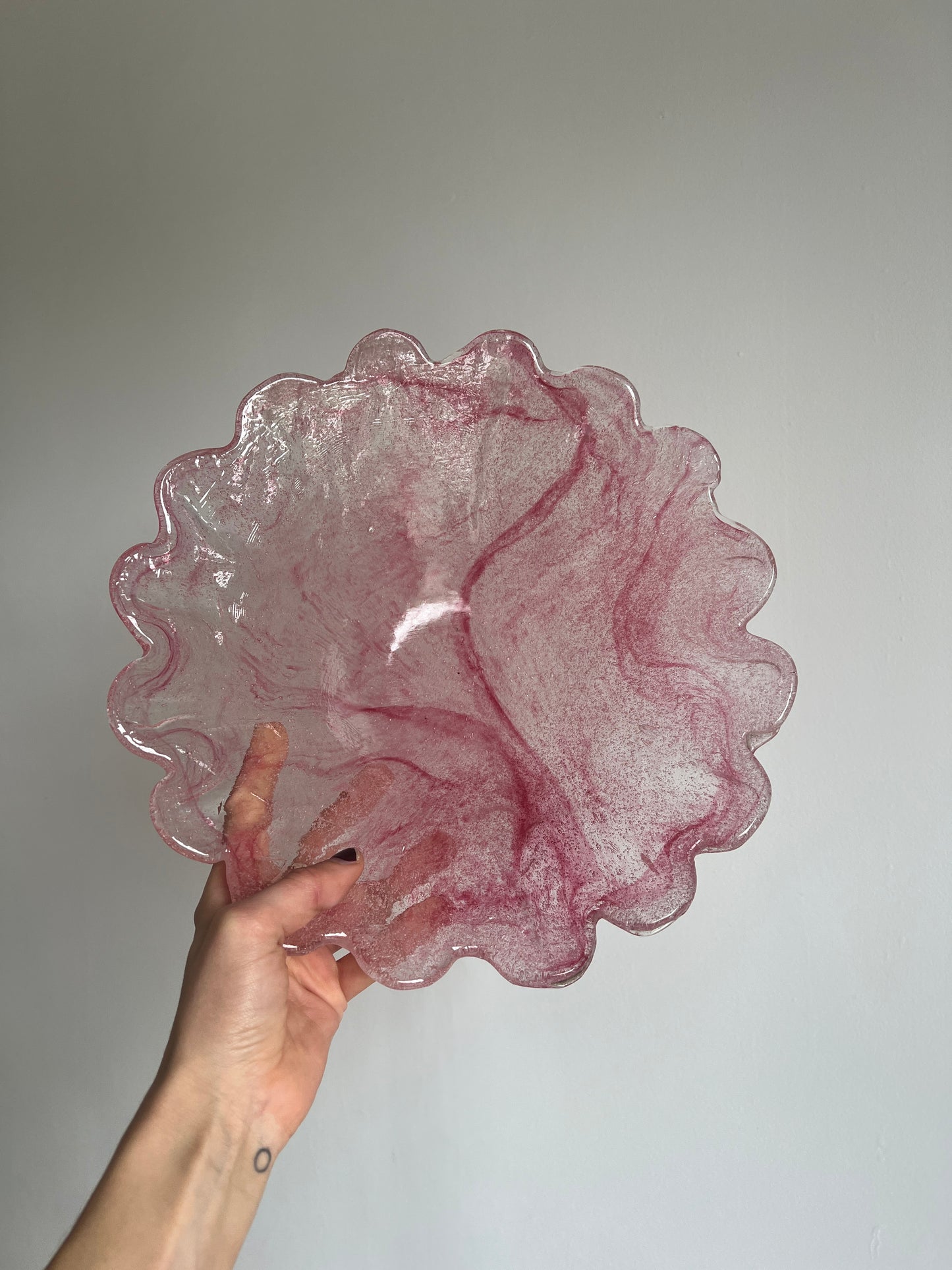 Large glass scalloped edge bowl with pink marbling