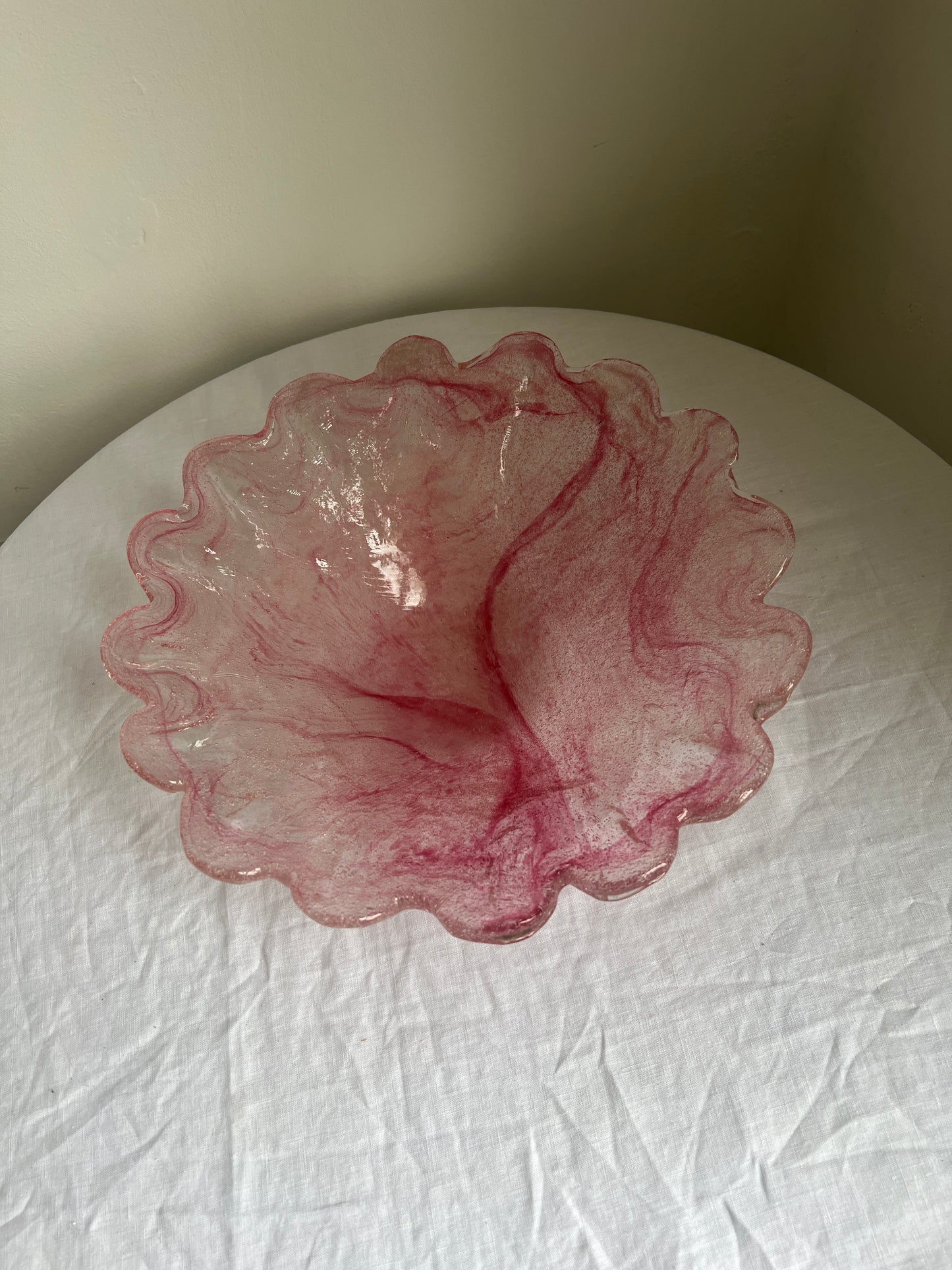 Large glass scalloped edge bowl with pink marbling