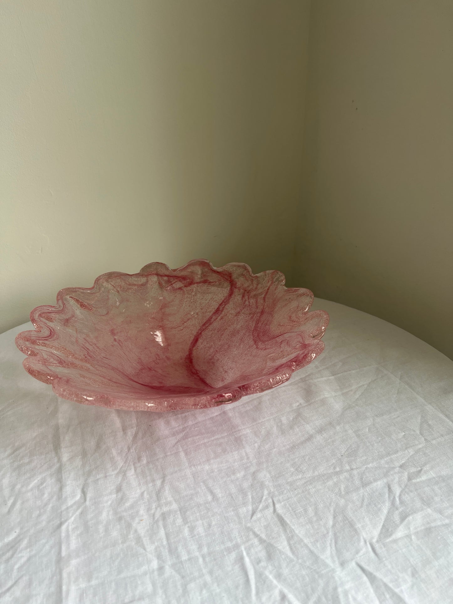 Large glass scalloped edge bowl with pink marbling