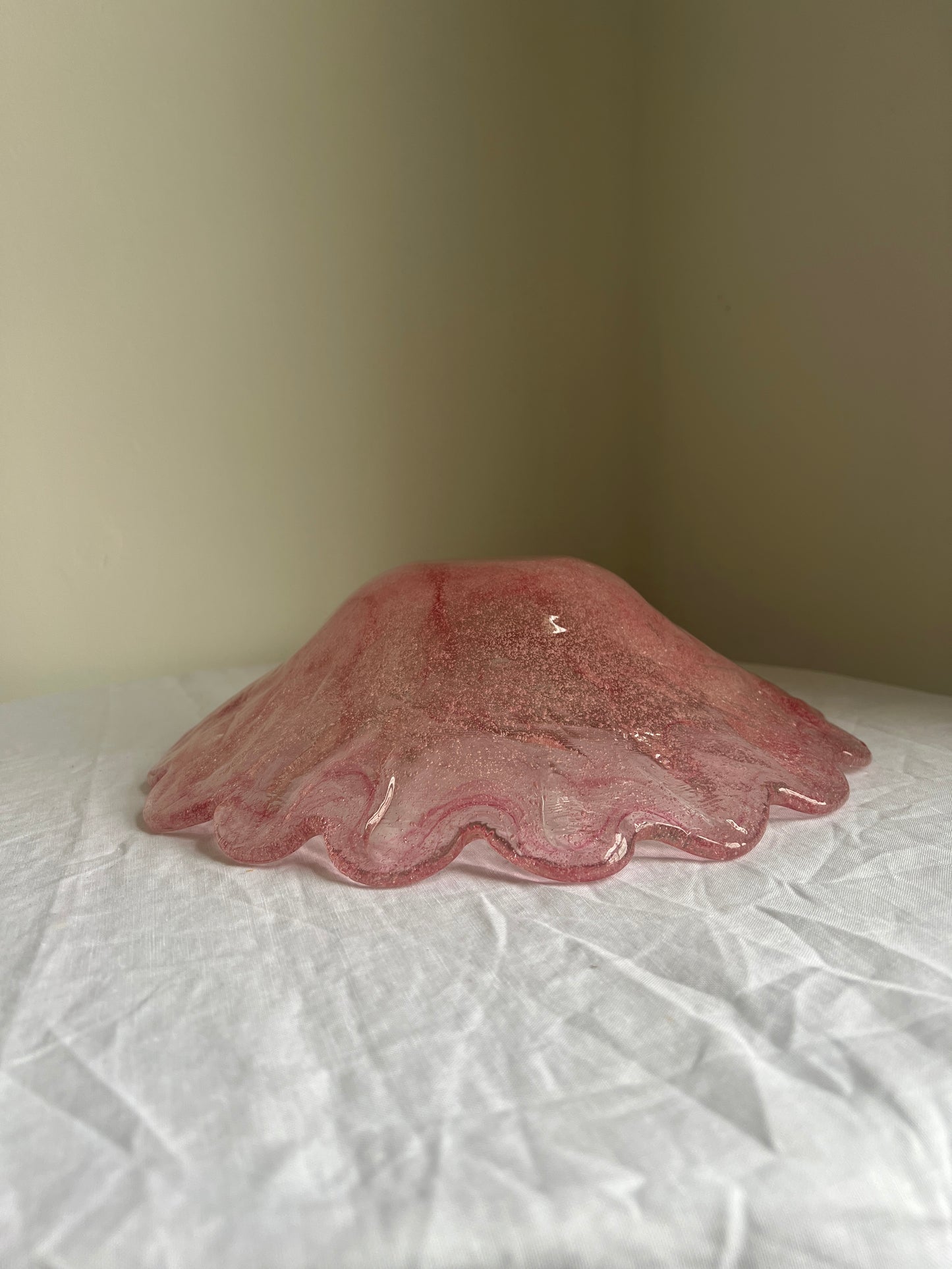 Large glass scalloped edge bowl with pink marbling