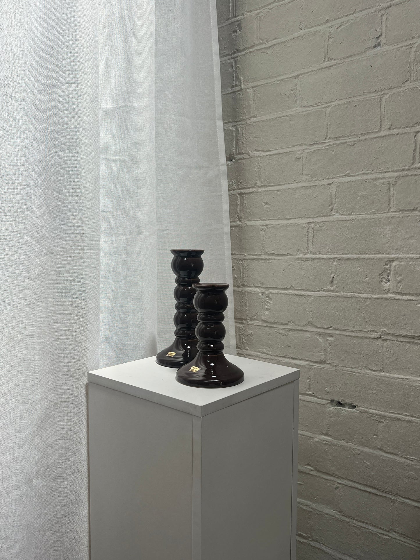 PAIR OF GLOSSY BROWN CANDLE STICKS